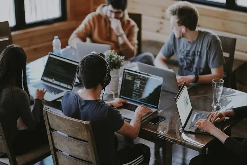 The RixDev team collaborating around a table